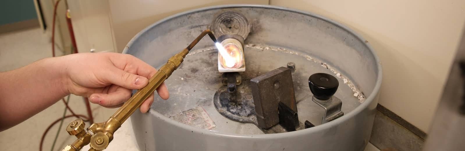 Camper gaining hands-on experience with silversmithing tools.