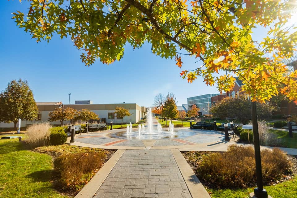 Columbia College quad, with Alumni fountain in motion, surrounded by sunshine on a fall day.