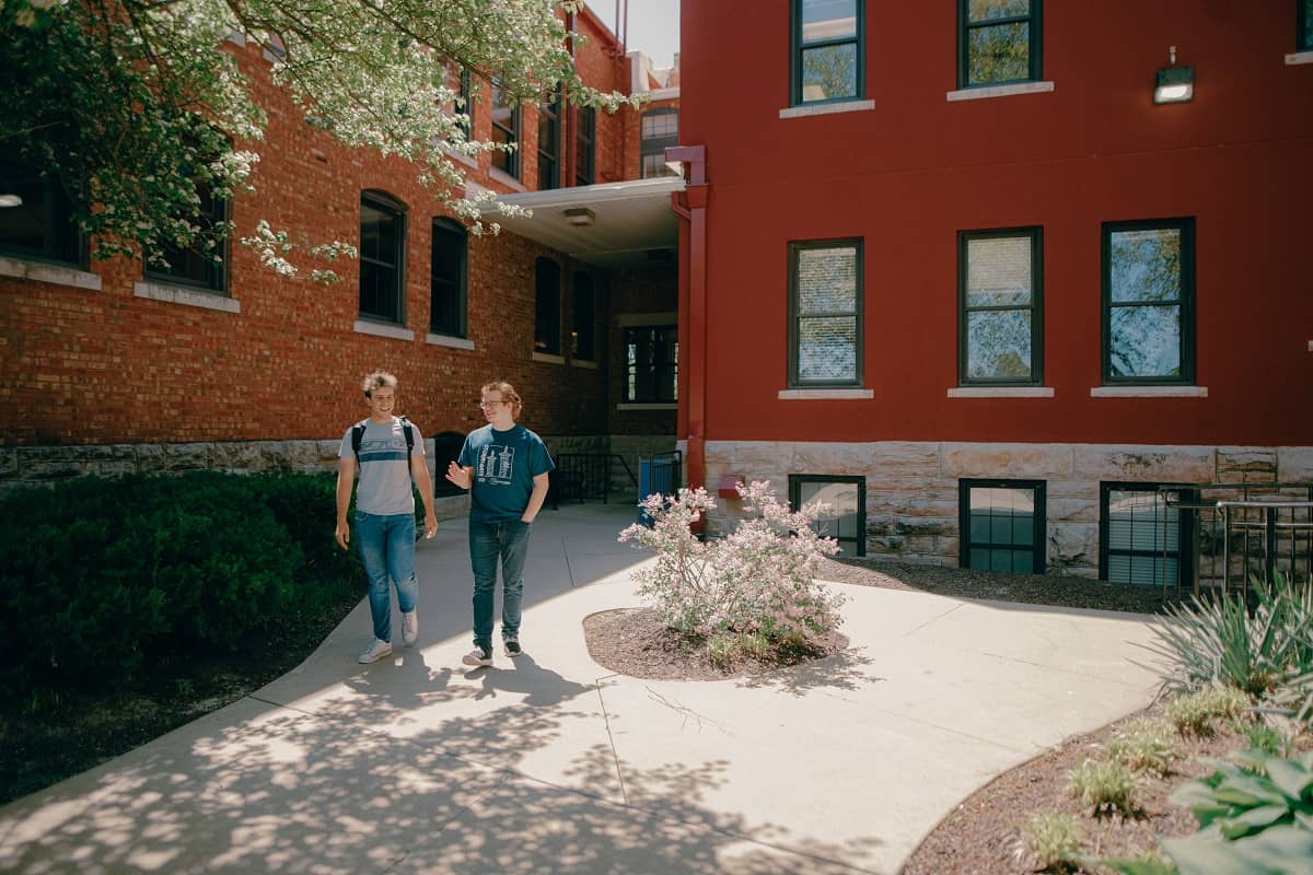 Student and prospective student walking outside main campus on a tour.