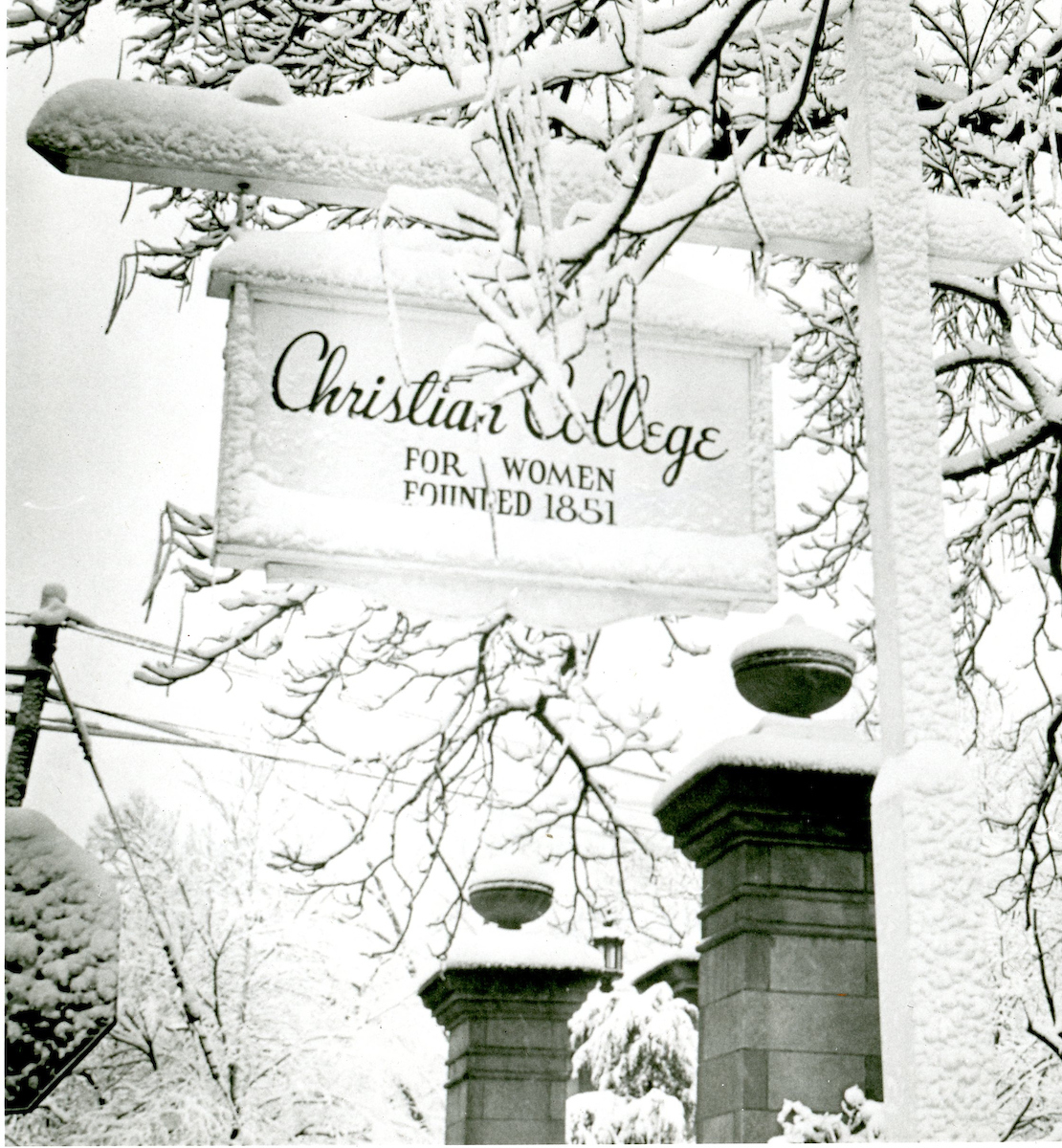 Sign hanging on main campus that reads "Christian College For Women Founded 1851".