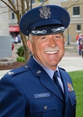 Color portrait of Col. David "Mike" Randerson, smiling at the camera.