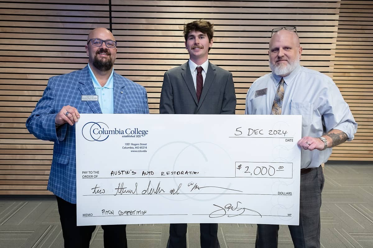 Austin Jansen poses for a photo after receiving $2,000 for his business Austin’s Automotive Restoration in the 2024 Pitch Competition.